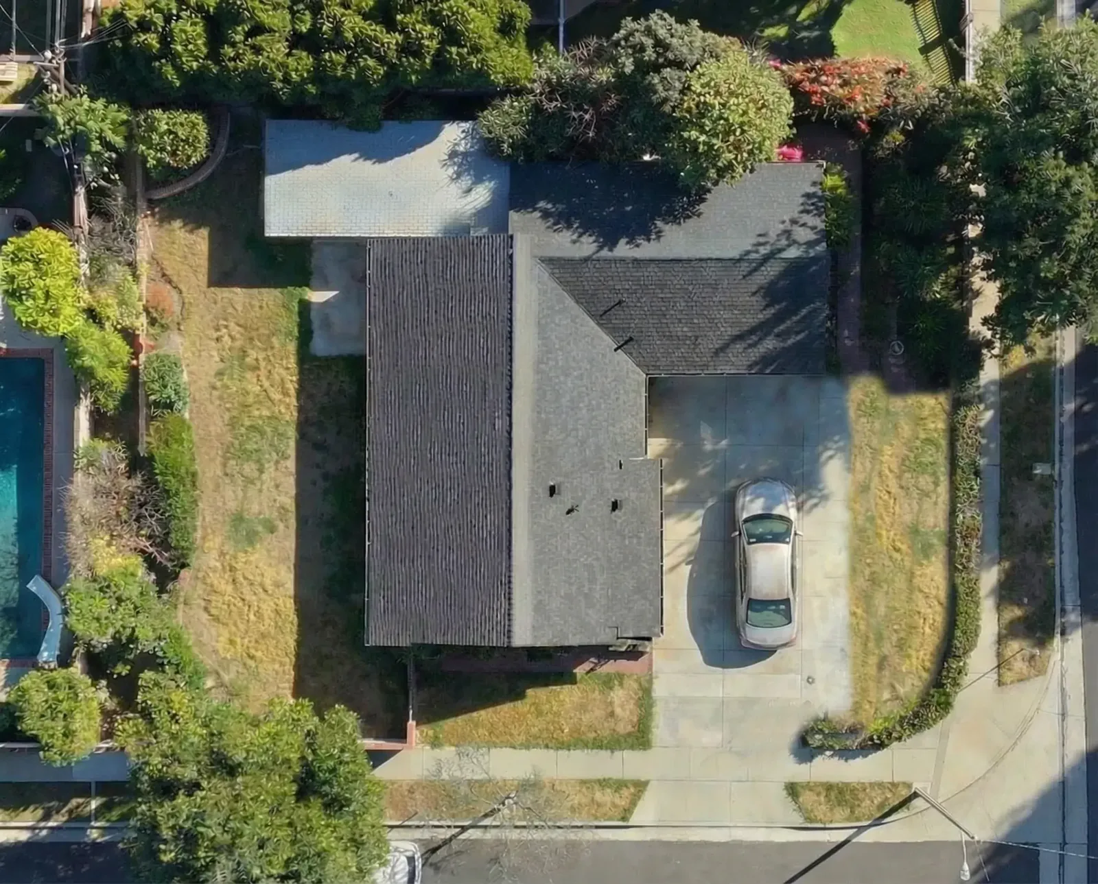 Aerial view of the Walnut property before construction: a single 1,200 square foot house on a corner lot with a pool and a large side yard