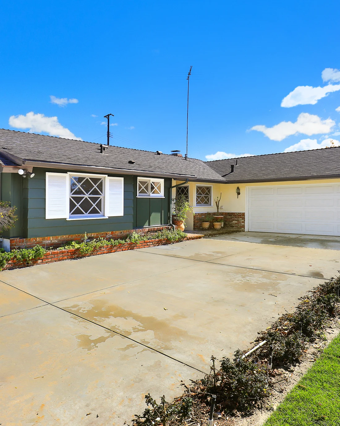 Street view of the renovated Walnut ranch house reading as a single home